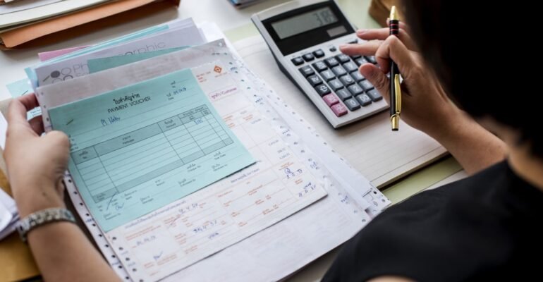 asian-woman-working-through-paperwork-min